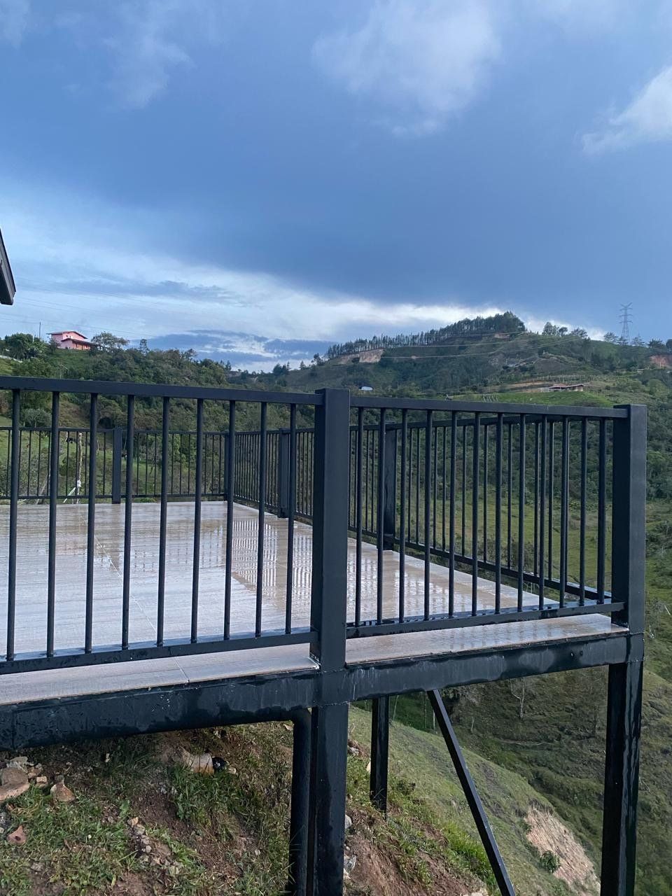 Terraza en voladizo con baranda negra, estructura en acero y metaldeck